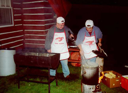 Don Maclean & Ralph Heighton cook up a mess of sausages and corn for the Sunday night mixer