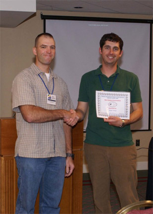 2009 President Ernie Atkinson presents Dylan Weese with the Best Student Paper Award.
